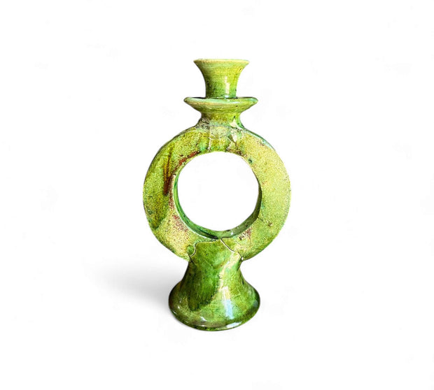 Green ceramic candle holder on a white background