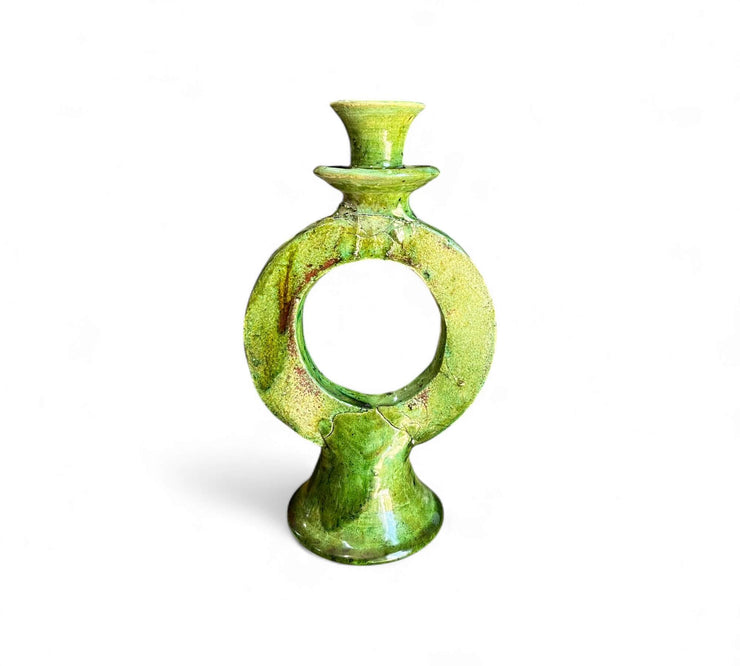 Green ceramic candle holder on a white background