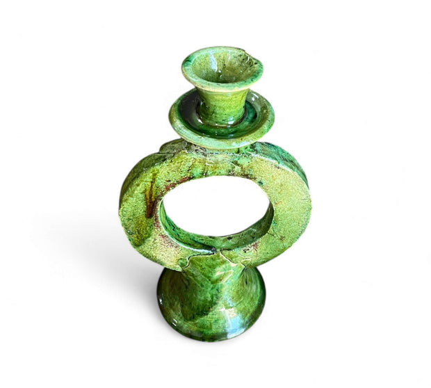 Green ceramic candle holder on a white background