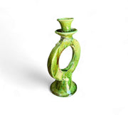 Green ceramic candle holder on a white background