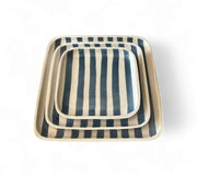 Set of three square ceramic trays with blue and white striped pattern on a white background