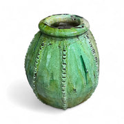 Green textured ceramic vase on a white background