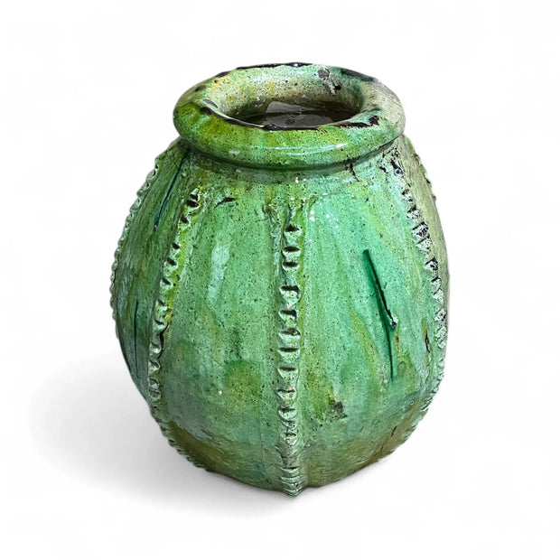 Green textured ceramic vase on a white background