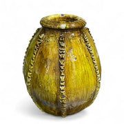 Decorative yellow vase with textured design on a white background
