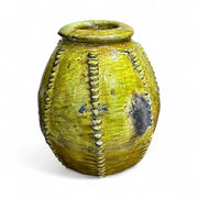 Yellow ceramic vase with textured design on a white background