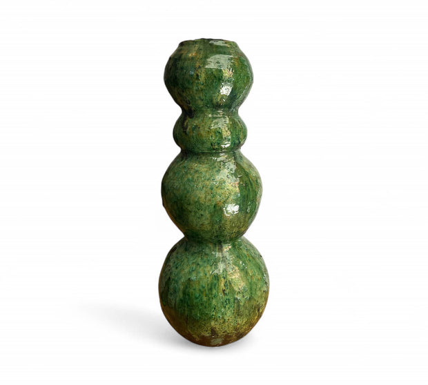 Green ceramic vase with three spherical sections on a white background