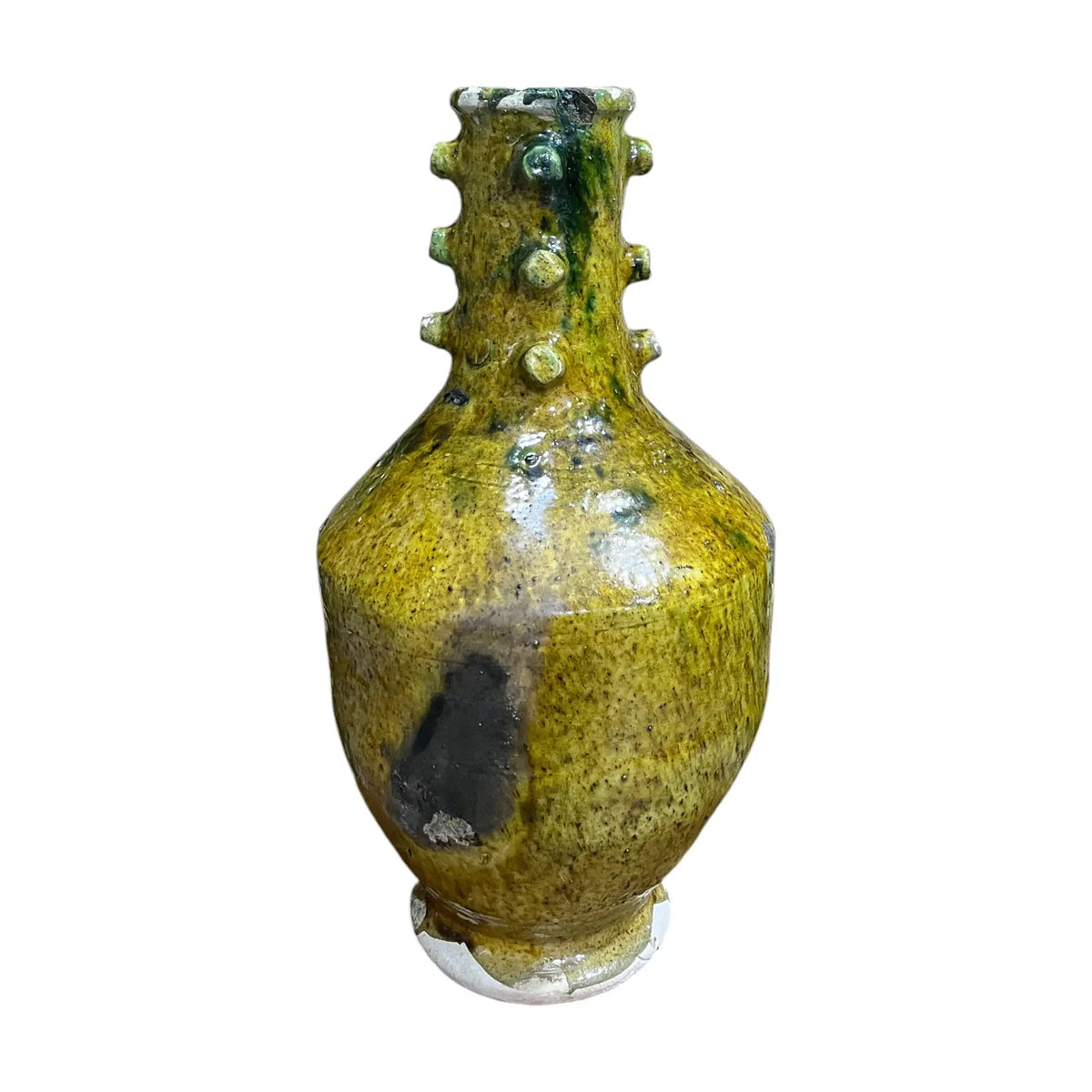 Yellow ceramic vase with textured surface on a white background