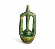 Green ceramic vase with textured surface on a white background