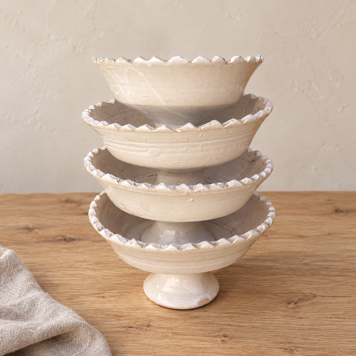 White Tamegroute ceramic pedestal fruit bowl with a jagged rim, handmade in Morocco.