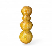 Yellow decorative object with a textured surface on a white background
