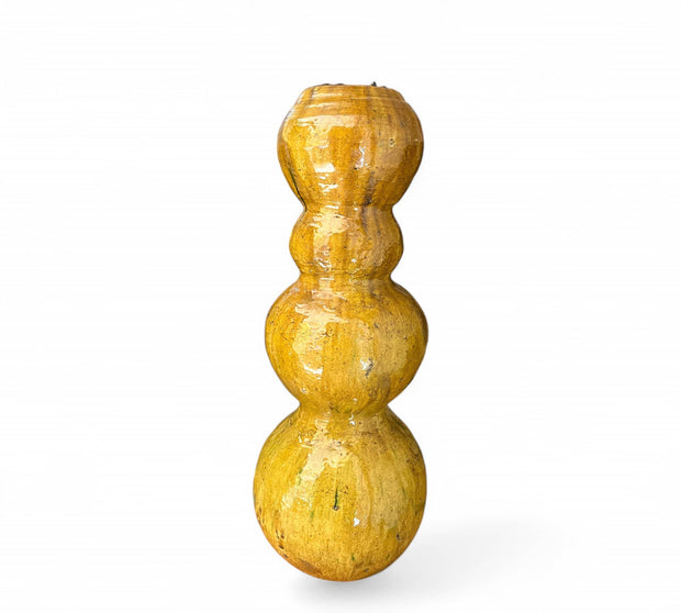 Yellow decorative object with a textured surface on a white background