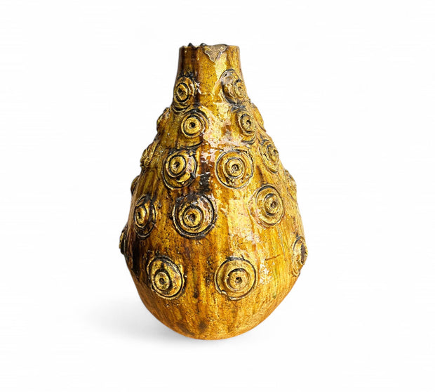 Decorative vase with circular patterns on a white background