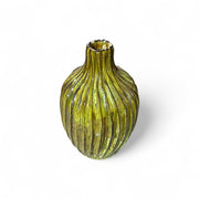 Yellow ribbed vase on a white background