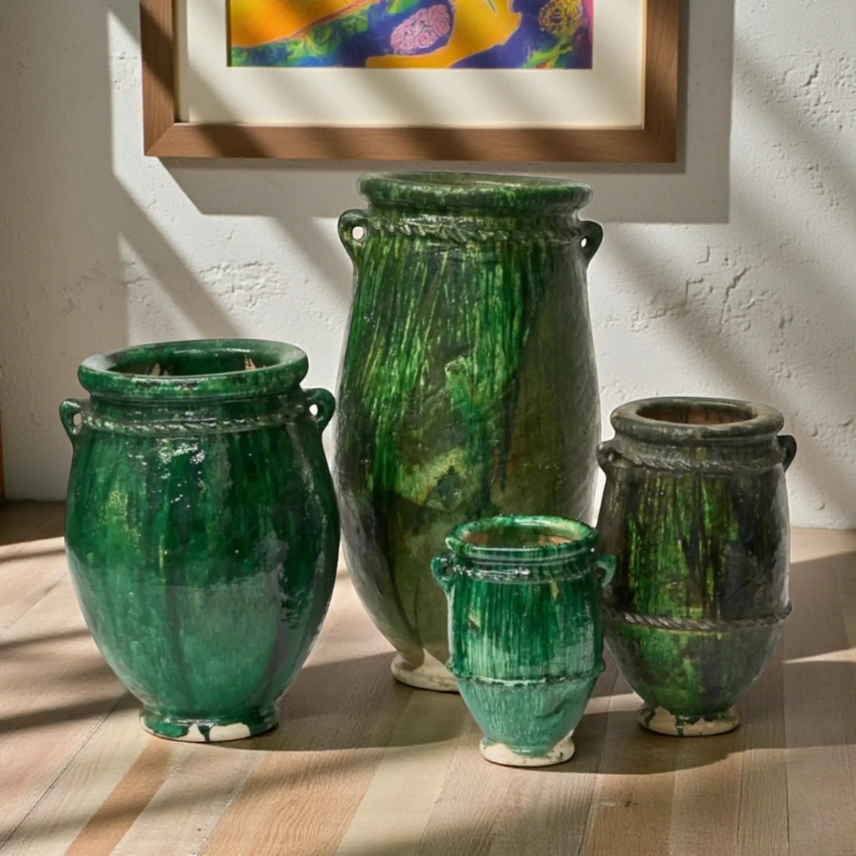 Tall handmade Tamegroute ceramic vases in traditional green glaze displayed as Moroccan floor pottery
