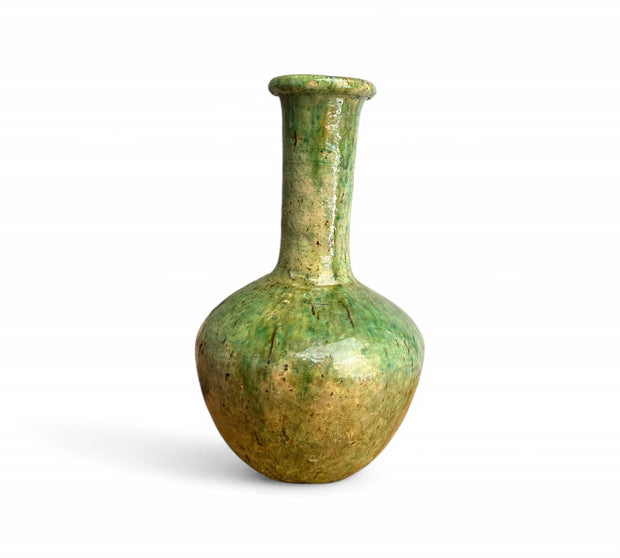 Green ceramic vase on a white background