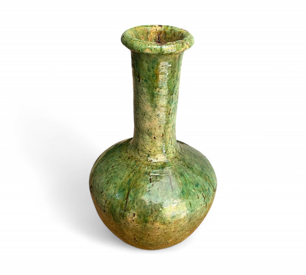 Green ceramic vase on a white background