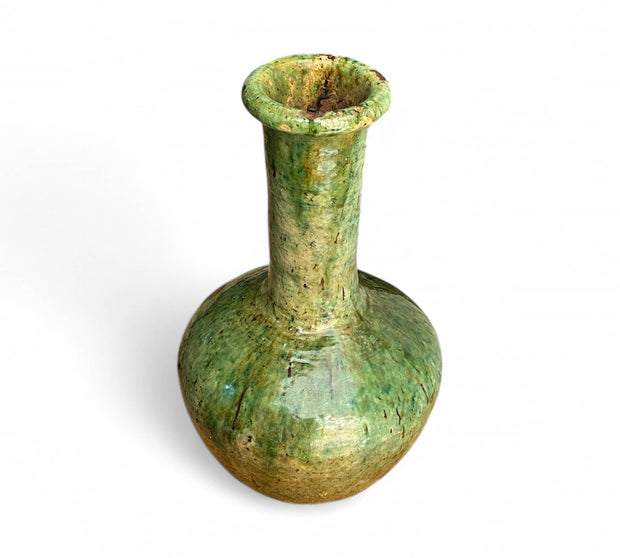 Green ceramic vase on a white background