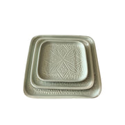 Set of two square ceramic trays with embossed designs on a white background